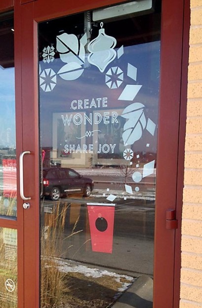 A Starbucks Coffee door with the phrase "Create Wonder and Share Joy".