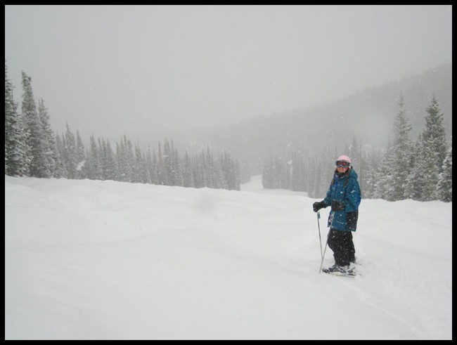 A woman skiing in heavy snowfall at Copper Mountain