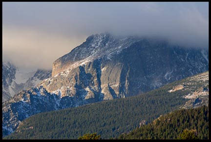 The morning lights hits mountain covered with fog in Rocky Mountain National Park