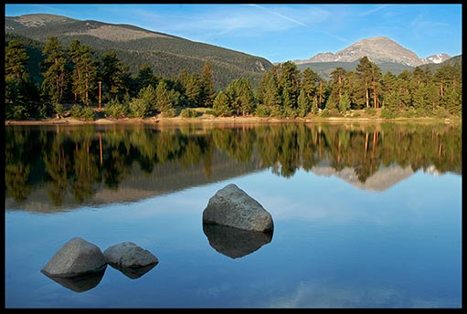 A mountain reflects in a still lake in Rocky Mountain National Park, Colorado. Should Christians embrace Creation care