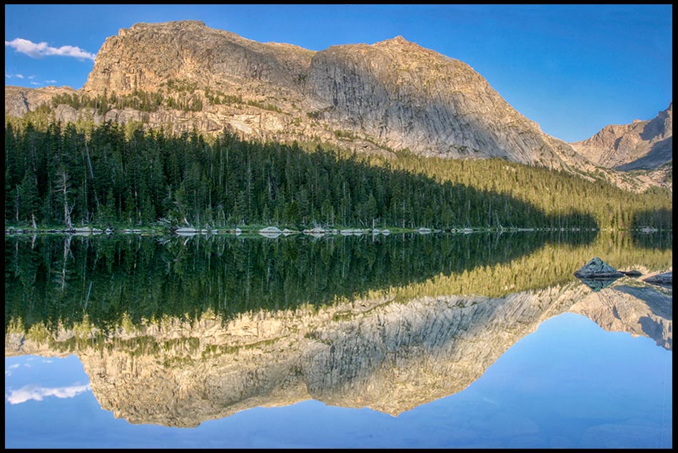 A surrounding mountains reflect in Cathedral Lake, Wyoming. Psalm 91:1 Shadow of the Almighty Bible verse