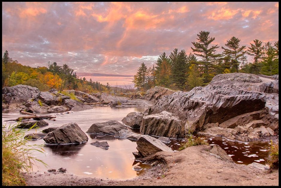 Rocks along the Saint Louis River just before sunrise in Jay Cooke State Park, Minnesota and Matthew 7:24-25, the rock of Christ teaching