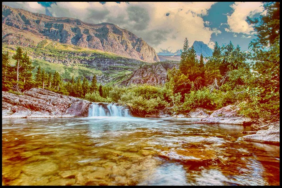 Redrock Falls surrounded by the mountains Glacier National Park, Montana and Isaiah 12:3-4. Springs of Salvation