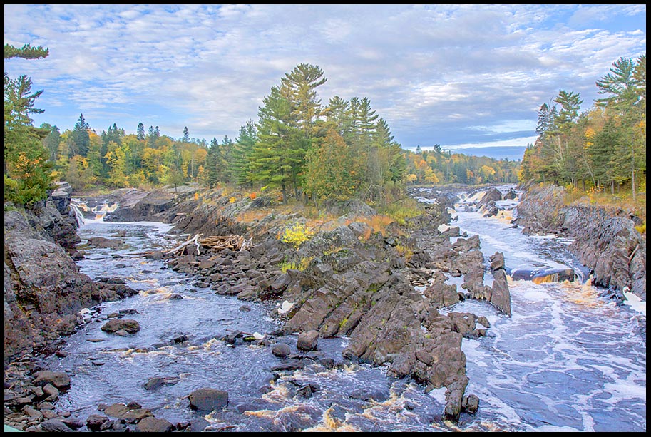 Water flows around a rock island in the Saint Louis River, Jay Cooke State Park, Minnesota and Psalm 25:6-7 Bible Verse God's mercy flows over us