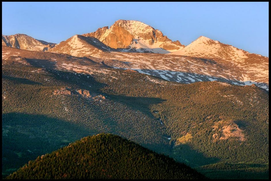 Snow covers parts Longs Peak on clear morning with a bright blue sky, Rocky Mountain National Park, Colorado and Psalm 65:8 Bible verse filled with Awe