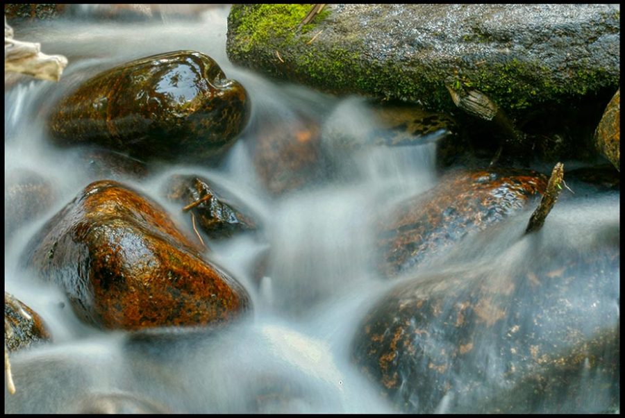 Water flows through the rocks of Calypso Cascade, Rocky Mountain National Park, Colorado. Bible Verse Luke 19:39-40 the rocks cry out