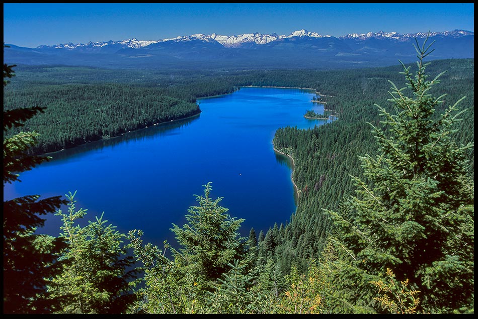 Looking down on a deep blue Holland Lake on a clear day in the Flathead National Forest near the Bob Marshall Wilderness, Montana and Psalm 107:9. satisfaction for the thirsty soul