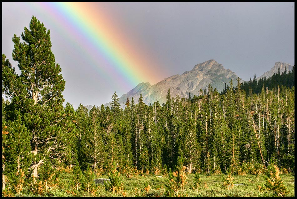 Rainbow over a mountain Wind Rivers Wilderness, Wyoming and Psalm 46:10 Bible verse. Cease striving an know I am God.