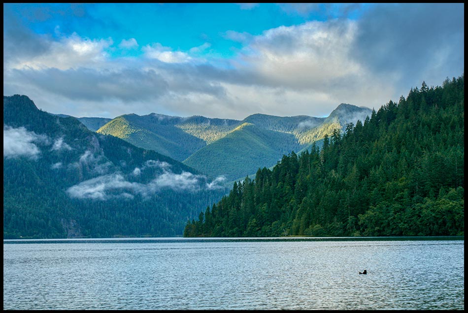Bible verse of the Day, Clouds and blue sky over Lake Crescent, Olympic National Park, Washington State, and Psalm 104:5-7.