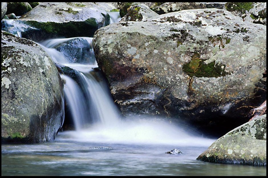 A small waterfall flows over rocks in a stream, Pisgah National Forest, North Carolina and John 7:38 Bible verse about living water