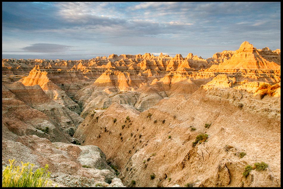 Sunrise strikes the a rocky valley Landscape, Badlands National Park, South Dakota and Psalm 27:5 Bible verse Lord, conceal me