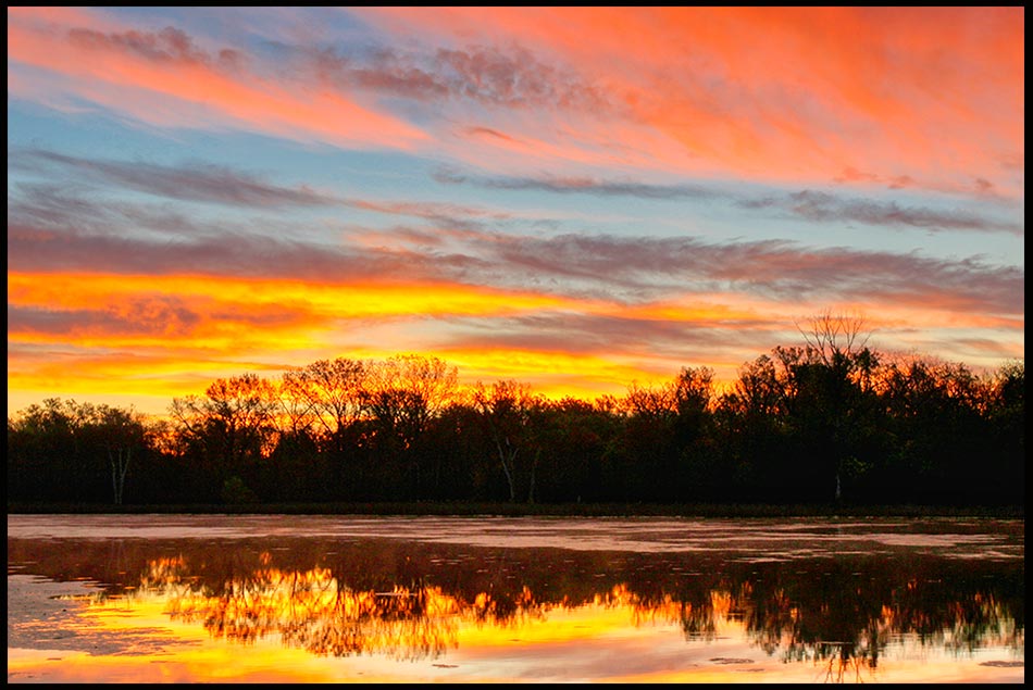 An orange, red and blue sunrise at Fontenelle Forest, Nebraska and Psalm 19 bible verse