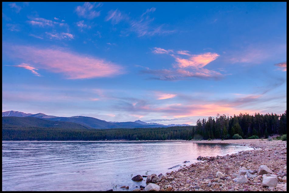 Magenta red clouds in a blue sky above Turquoise Lake, San Isabel National Forest, Colorado. God lives in the highest heaven. Bible verse of the day