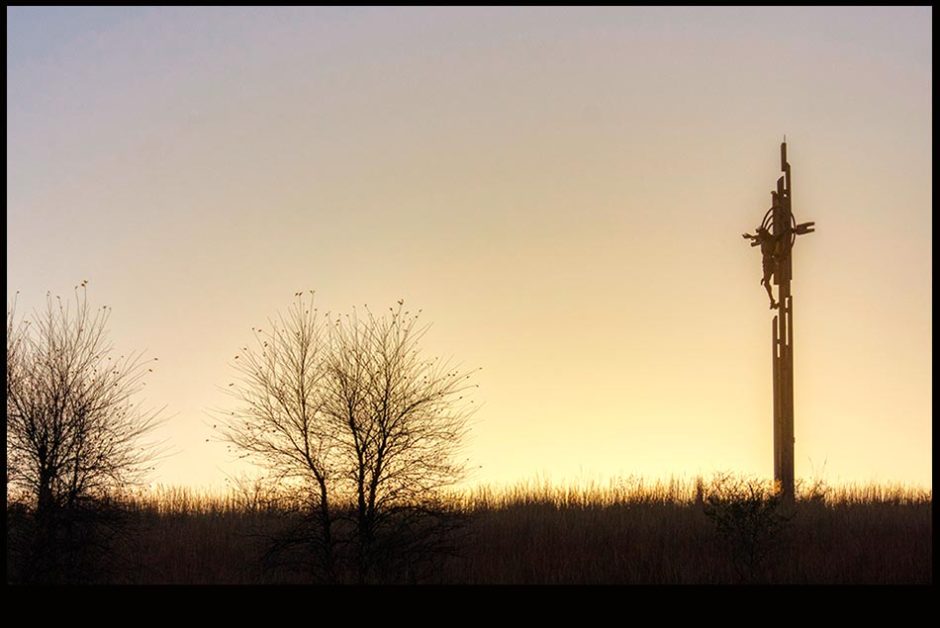 A silhouetted cross of Christ at sunrise, Holy Family Shrine, Eastern Nebraska. Bible Verse of the Day: Luke 23:46 Father, into your hands I commit my spirit