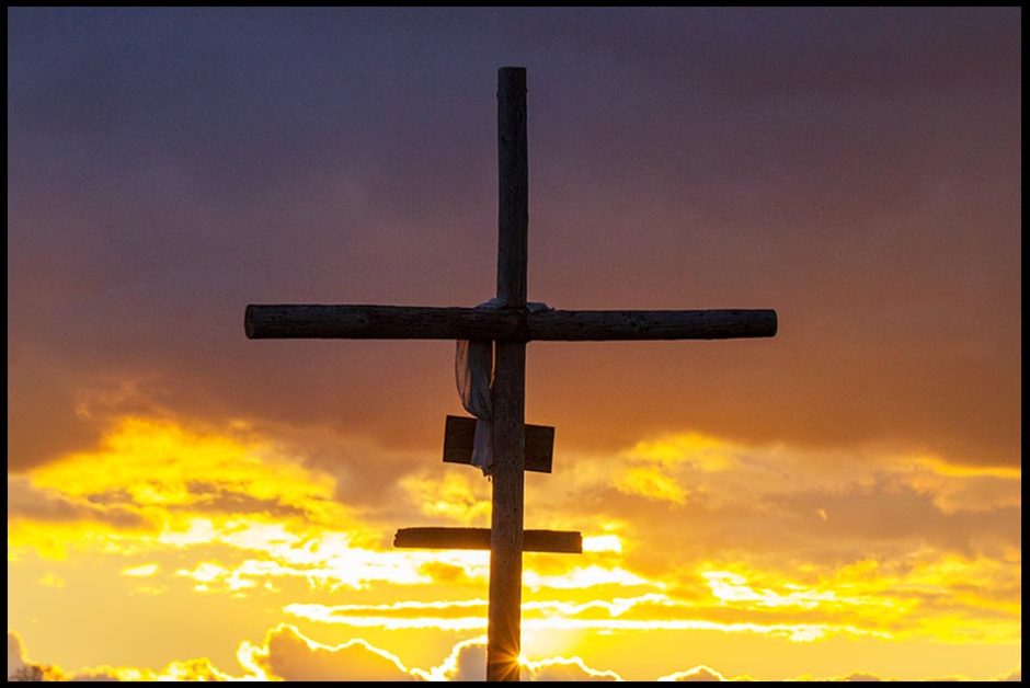 An empty silhouetted cross at sunset with clouds, Papillion, Nebraska Luke 23 and laid in a tomb