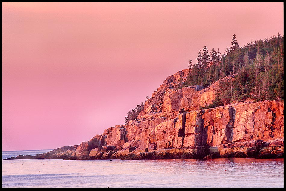 The red glow of sunrise hits the Otter Cliffs of Acadia National Park, Maine and Psalm 108:4-5 Be exalted, O God