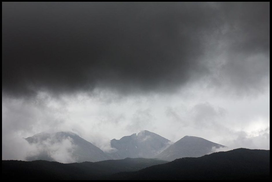 Storm clouds over Longs Peak and other mountains in Rocky Mountain National Park, Colorado and Nahum 1:3 Bible verse and God's wrath