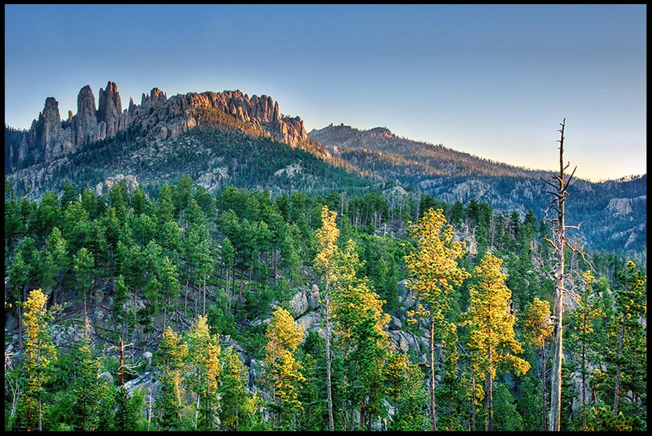 The Pinnacles rock formation above the surrounding landscape at sunrise, Black Hills, South Dakota. Bible Verse of the Day: Acts 17:24-25. The God who made the world