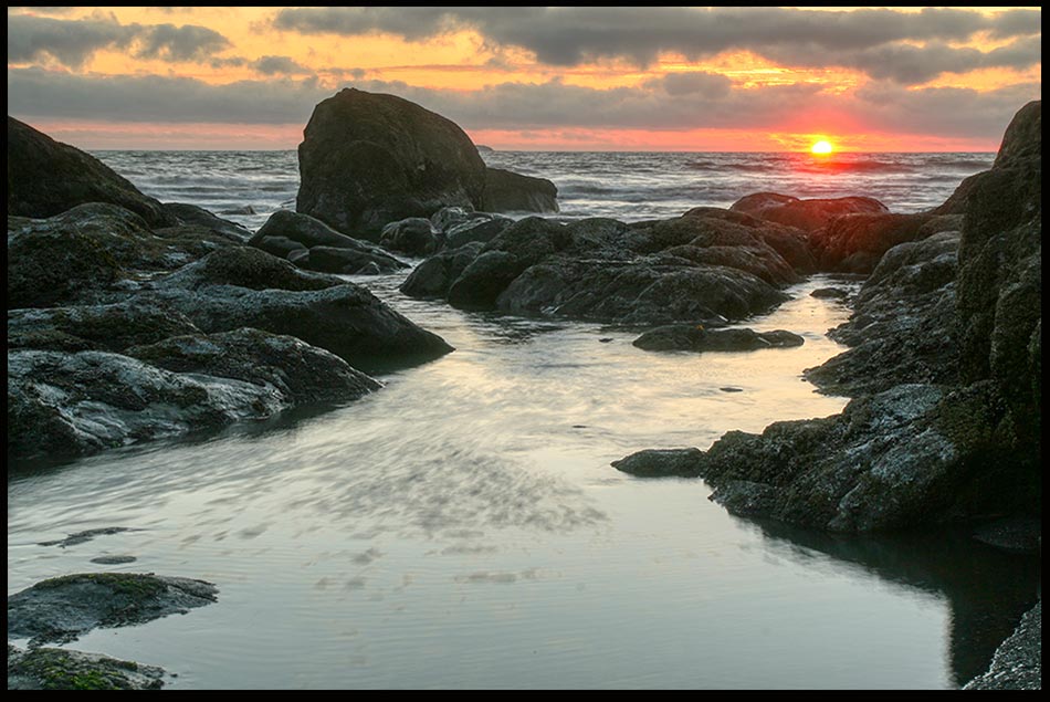 Sunset over rocky shoreline beach of Olympic National Park, Washington State and Jeremiah 31:35 God gives the sun Bible Verse of the Day: