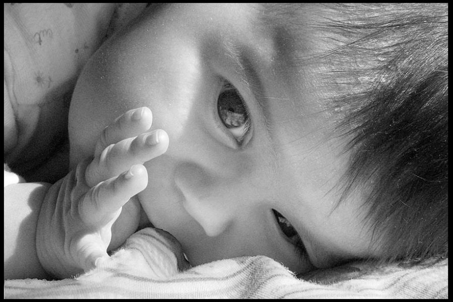 A face shot of an infant child sucker her thumb in black and white photo. Bible verse of the day Psalm 139:13 Pray for the unborn