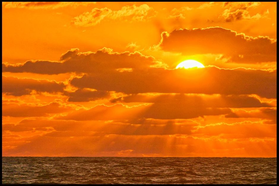  A sunrise rise through clouds over the Atlantic Ocean, Melbourne Beach, Florida. Bible Verse of the Day: Habakkuk 3:4 God's radiant power