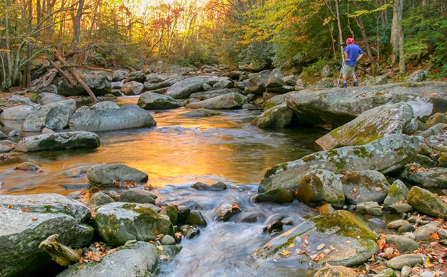 A photographer by a Smoky Mountain National Park stream in the fall illustrating spiritual photography