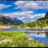 Blue water, blue sky and white clouds and the mouth of Bullhead Lake, Glacier National Park, Montana and Genesis 2:1-2 Bible verse God completed His work