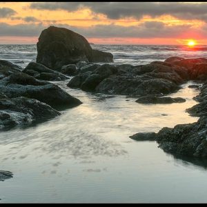 Sunset over rocky shoreline beach of Olympic National Park, Washington State and Jeremiah 31:35 God gives the sun Bible Verse of the Day: