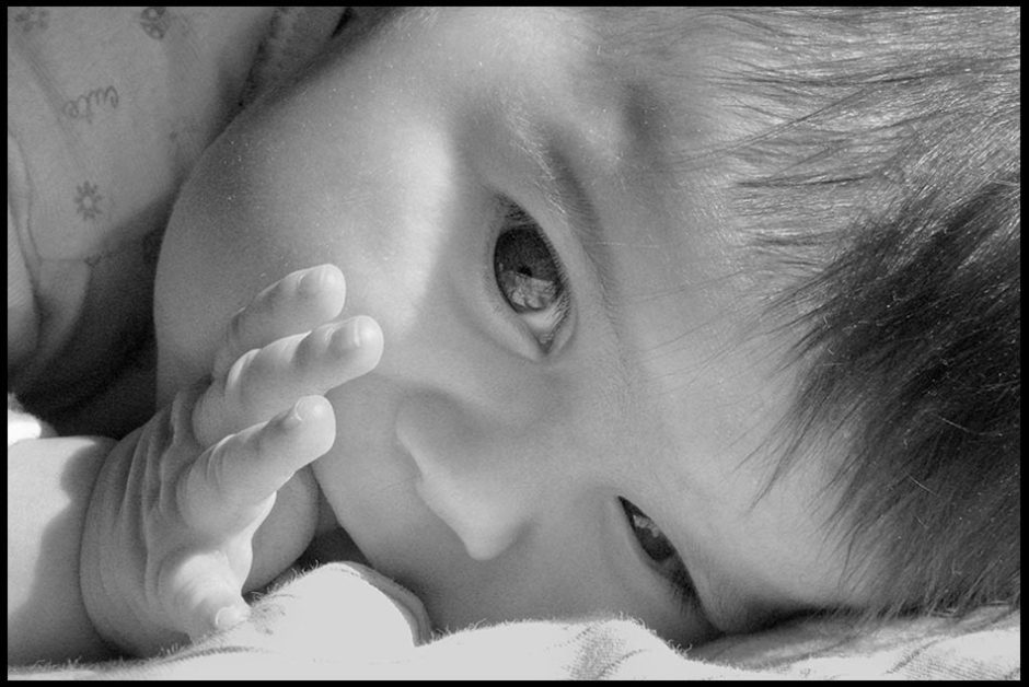 A face shot of an infant child sucker her thumb in black and white photo. Bible verse of the day Psalm 139:13 Pray for the unborn children