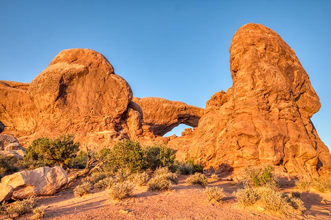 Desert rocks and a partial view of one of the Windows in Arches national Park. This photo is to illustrate eliminating our shadows in our photographs.