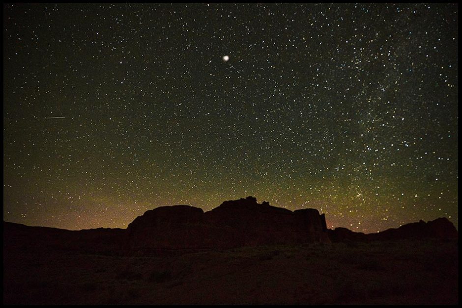 A star filled sky over Arches national Park with one star enhance to appear as the Christmas star. Visual Bible verse of the day Matthew chapter 2. filled sky over Arches national Park with one star enhance to appear as the Christmas star. Visual Bible verse of the day Matthew chapter 2.